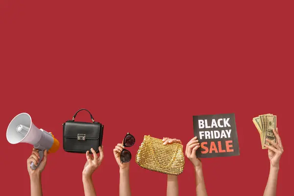 Female hands holding poster with text BLACK FRIDAY SALE, money, megaphone and women accessories on red background