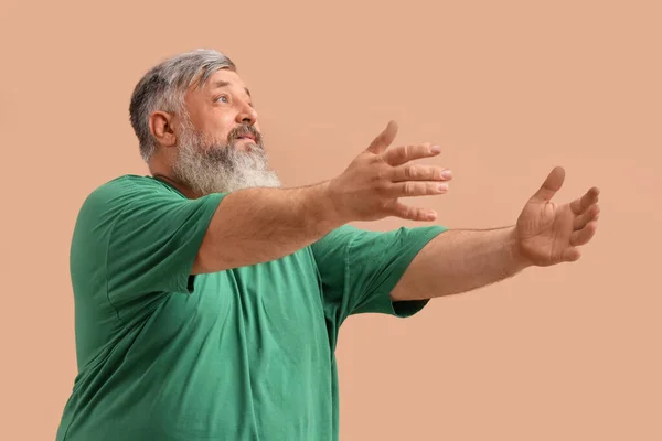 stock image Mature man opening arms for hug on color background