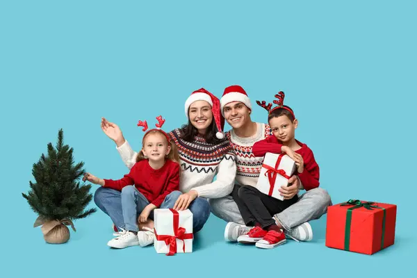 Família Feliz Camisolas Quentes Com Presentes Natal Árvore Fundo Azul — Fotografia de Stock
