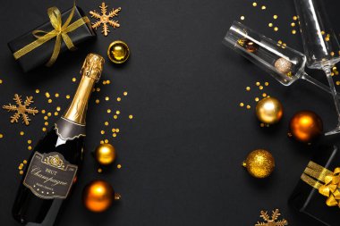Şampanya şişesi, bardaklar ve koyu arkaplanda güzel Noel süslemeleri olan kompozisyon
