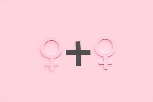 Female gender symbols on pink background. LGBT concept
