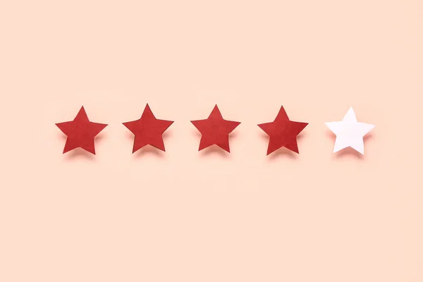 Four out of five stars rating on pink background. Customer experience concept