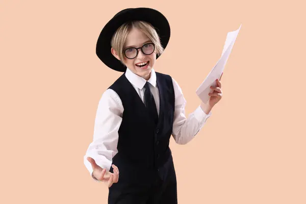 Stock image Little actor with film script on beige background