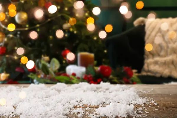 Empty wooden table with snow in room decorated for Christmas