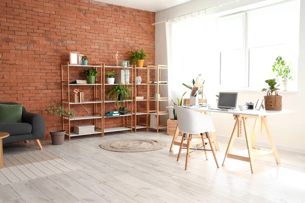 Interior of home office with workplace and shelf unit