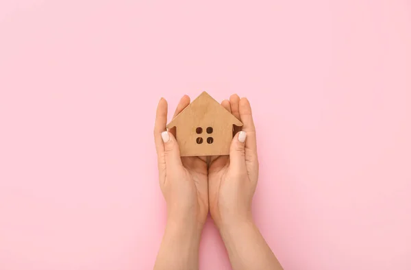 Female Hands Wooden House Figure Pink Background Concept Buying Real — Stock Photo, Image