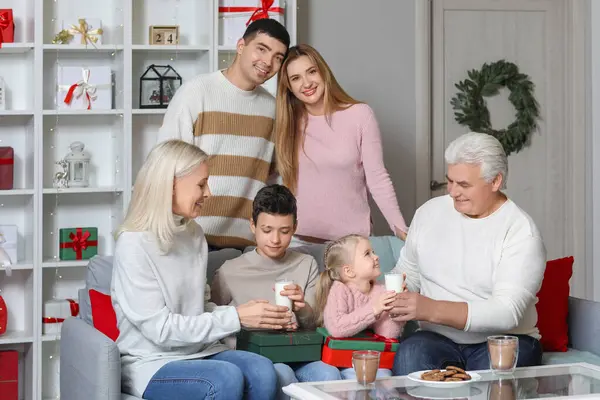 Happy family with Christmas cookies and milk at home