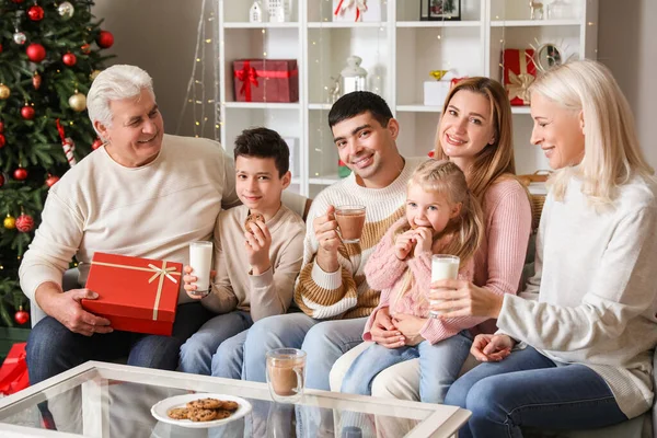 Happy family with cookies and milk at home on Christmas eve