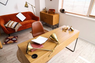 Dağınık ofiste modern işyeri ve kanepe.