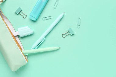 Turkuaz arka planda farklı kırtasiyeye sahip kalem kutusu