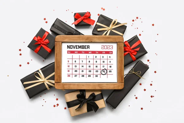 Calendar with date NOVEMBER 24 and gift boxes on white background. Black Friday sale