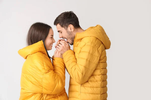 Loving Couple Winter Clothes Warming Hands Light Background — Stock Photo, Image