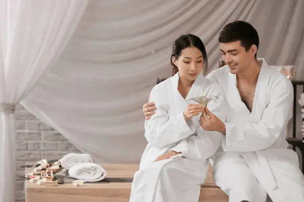 Young couple with flower in spa salon