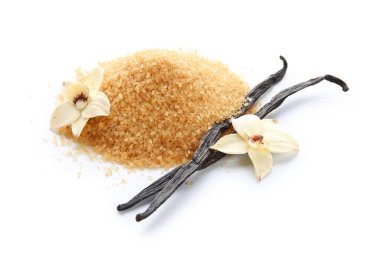 Bir yığın aromatik vanilya şekeri, çiçekler ve beyaz arka planda çubuklar.