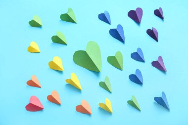 Mavi arka planda renkli kağıt kalpler. LGBT kavramı