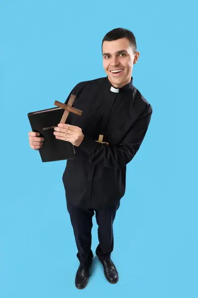 Young Priest Holy Bible Crosses Blue Background — Stock Photo, Image