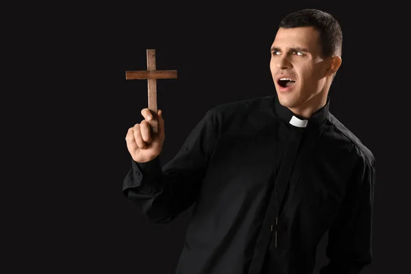Displeased Young Priest Cross Dark Background — Stock Photo, Image