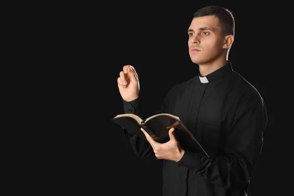 Young Priest Holy Bible Black Background — Stock Photo, Image