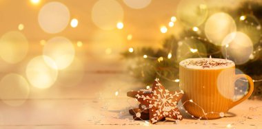 Masada bir fincan sıcak çikolata ve zencefilli kurabiye var. Tasarım için pankart