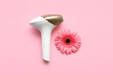 Pembe arka planda Gerbera çiçeği olan modern fotoepilator.