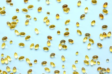 Mavi arka planda balık yağı hapları