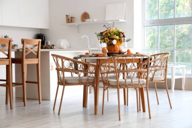 Mutfaktaki yemek masasında sonbahar çiçekli balkabağı.