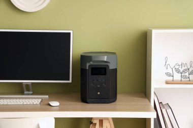 Workplace with computer and portable power station in office