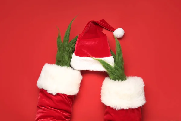 Green Hairy Hands Creature Costume Santa Hat Red Background — Stock Photo, Image