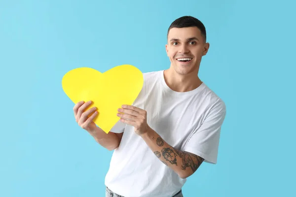 Happy Young Man Yellow Paper Heart Blue Background — Stock Photo, Image