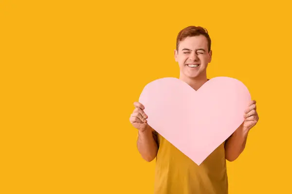 Happy Young Man Pink Paper Heart Yellow Background — Stock Photo, Image