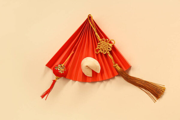 Fortune cookie with Chinese symbols on beige background. New Year celebration
