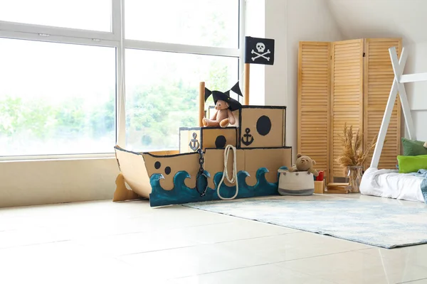 Pirate cardboard ship in interior of children\'s bedroom