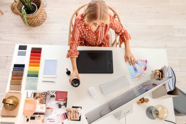 Ofisteki masadaki grafik tabletle çalışan kadın iç mimar, üst görünüm