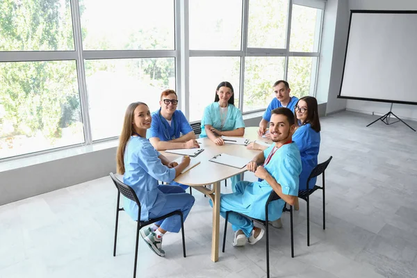 Group of medical students studying at table