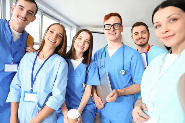 Group of medical students taking selfie at university
