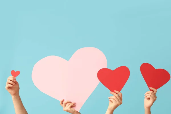 Mavi Arka Planda Kağıt Kalpli Kadın Eller Sevgililer Günü Kutlaması — Stok fotoğraf