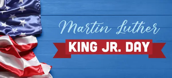 Banner for Martin Luther King Jr. Day with USA flag on blue wooden background