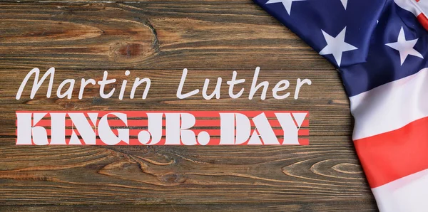 Banner for Martin Luther King Jr. Day with USA flag on wooden background