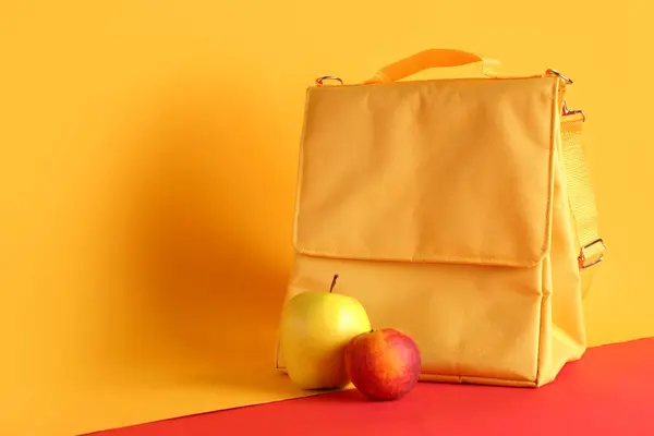 Lunch box bag and fruits on color background