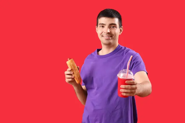 Happy Young Man Tasty French Hot Dog Drink Red Background — Stock Photo, Image