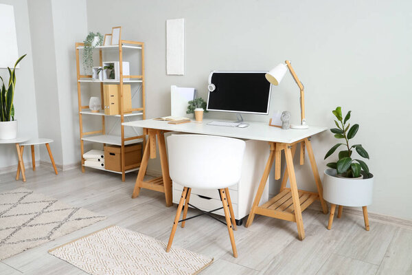 Stylish interior of light room with comfortable workplace