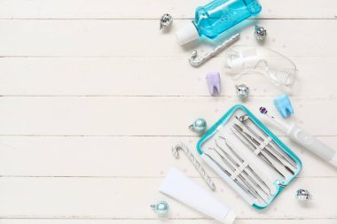 Dişçi aletleri ve hafif ahşap arka planda Noel süslemeleri ile kompozisyon