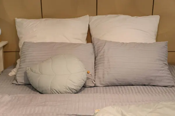 Big bed with soft pillows in cozy bedroom at night