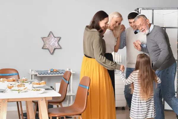 Happy family dancing at home on Hanukkah