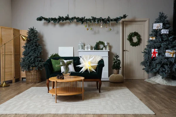 Interior of festive living room with green sofa, wooden coffee table and Christmas decorations