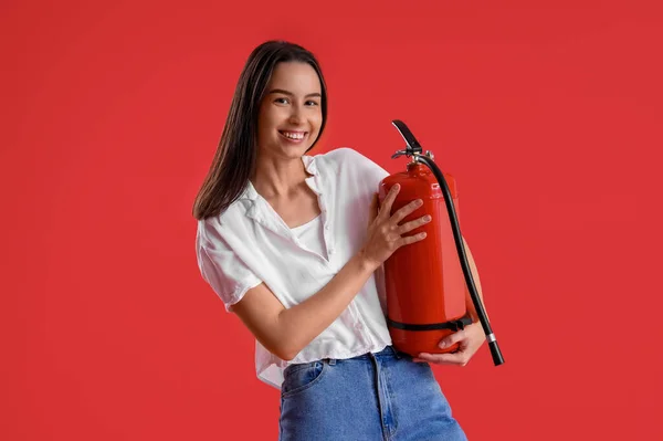Young Woman Fire Extinguisher Red Background — Stock Photo, Image