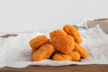 Beyaz arka planda lezzetli nugget ve biberli kağıt pişirme.