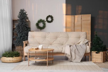 Rahat kanepe ve ökseotu çelenkleriyle modern oturma odasının şık bir iç mekanı.