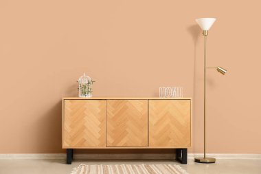 TV standı ve lamba bej duvarın yanında.