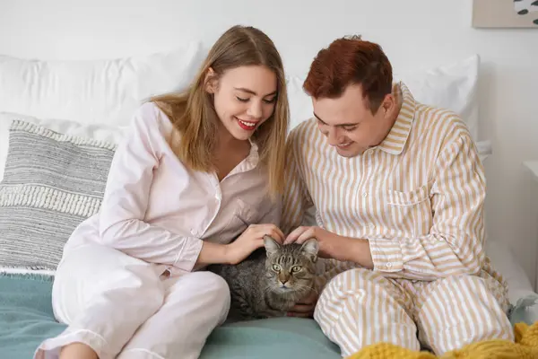 Stock image Young couple with cute cat in bedroom